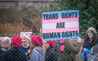 An image of a trans rights protest as Florida Governor Ron DeSantis attacks transgender care, or gender-affirming care, at Florida universities